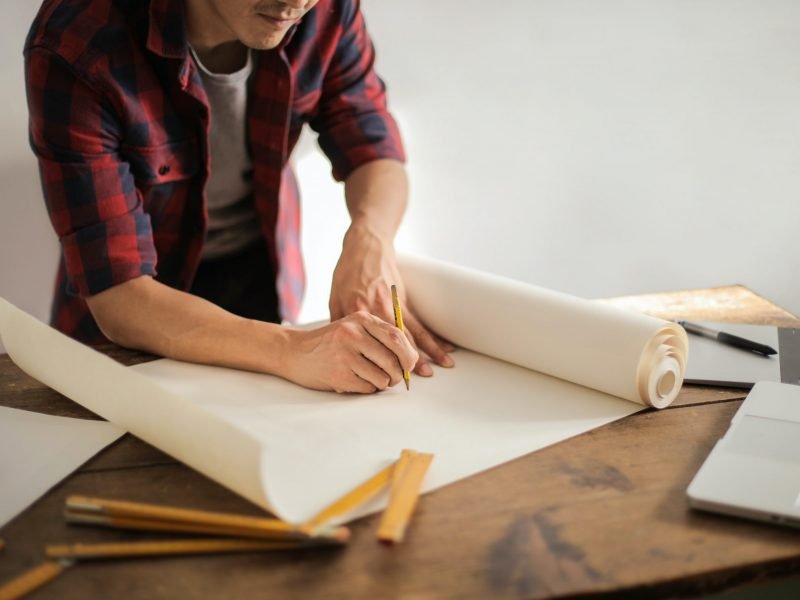 male-constructor-drawing-draft-on-paper-roll-3760529 male-constructor-drawing-draft-on-paper-roll-3760529